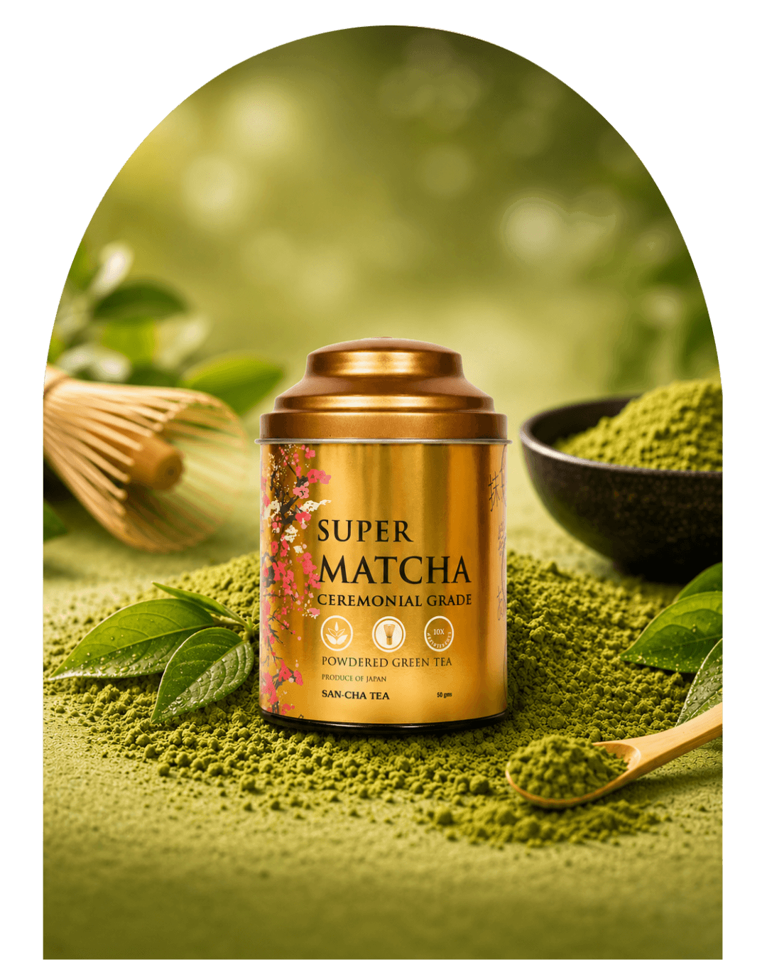A gold cylindrical tin of Super Matcha Ceremonial Grade powdered green tea sits on a bed of green tea powder, surrounded by matcha leaves, a wooden whisk, and a small bowl of matcha powder in a soft green, blurred setting.