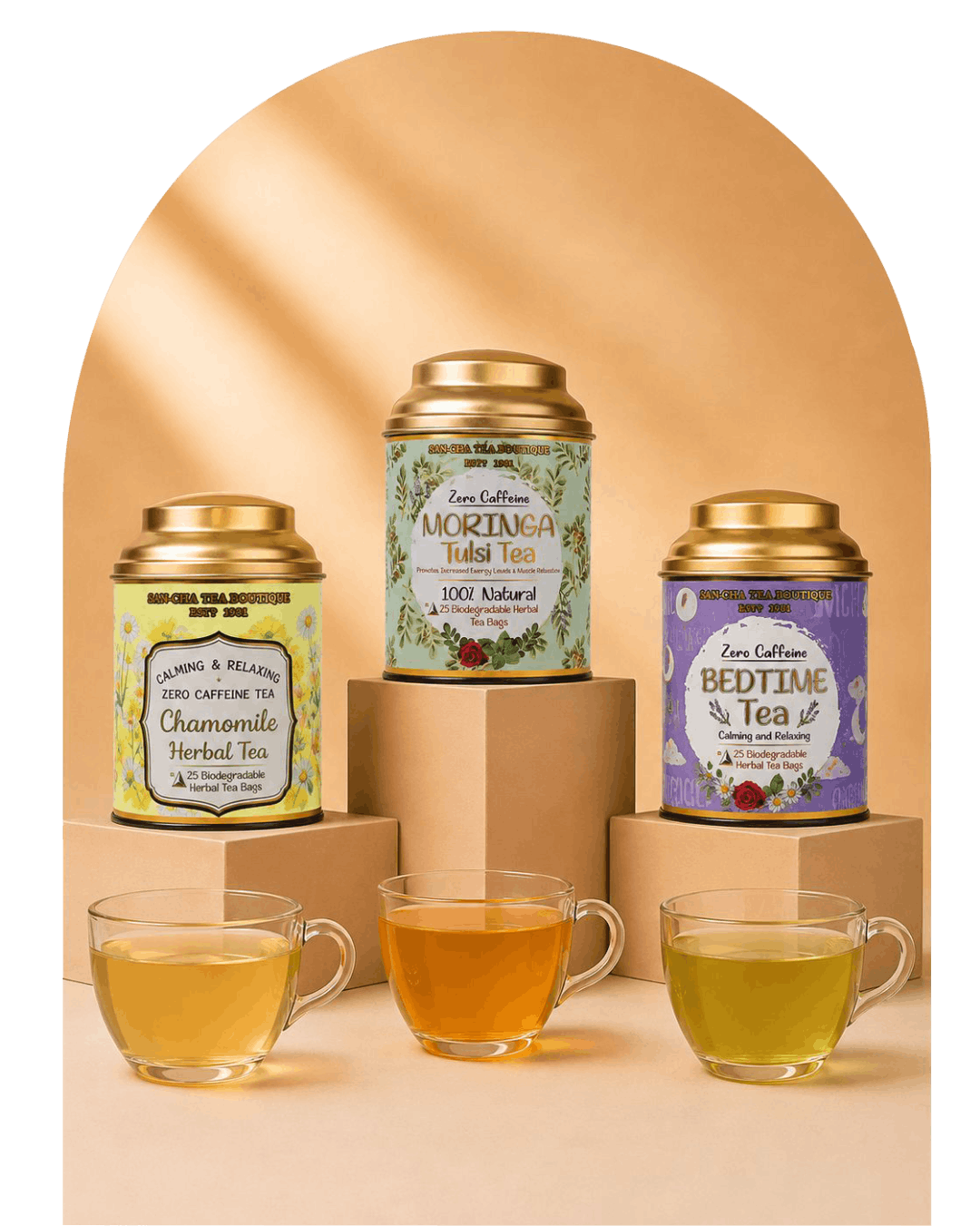 Three tea tins in different colors (yellow-green, green, and purple) with gold lids are displayed on cardboard risers with three glass teacups in front on a beige background with a soft arch shadow.