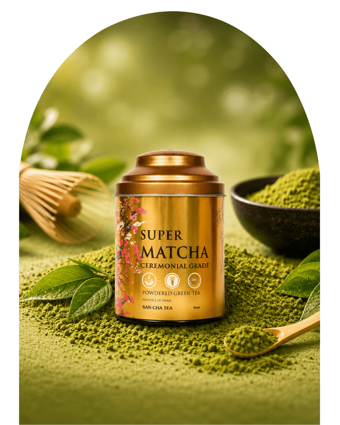 A gold cylindrical tin of Super Matcha Ceremonial Grade powdered green tea sits on a bed of green tea powder, surrounded by matcha leaves, a wooden whisk, and a small bowl of matcha powder in a soft green, blurred setting.